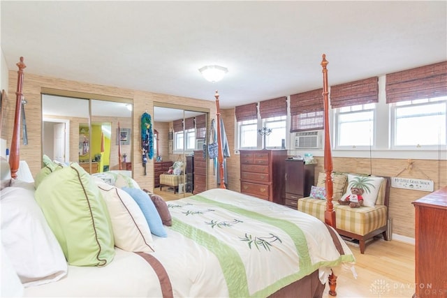 111 W Pinehurst St, Sidney, OH 45365 - bedroom with wood finished floors, two closets, and cooling unit