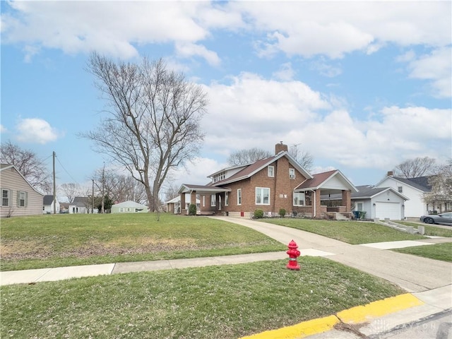 111 W Pinehurst St, Sidney, OH 45365 - view of front of property with a chimney, concrete driveway, a front yard, and brick siding