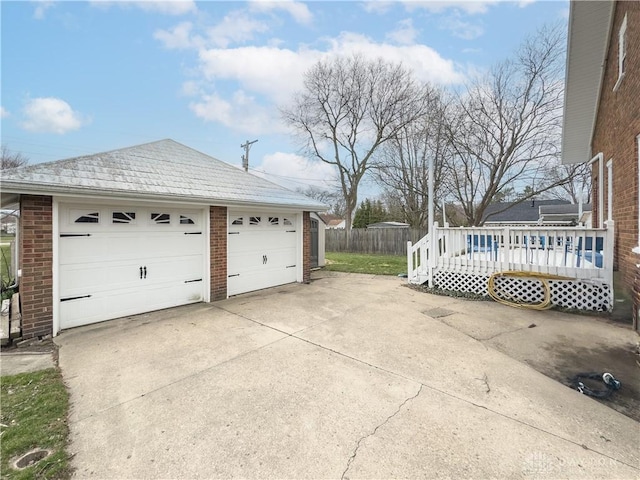 111 W Pinehurst St, Sidney, OH 45365 - view of side of property featuring fence, an outdoor structure, a detached garage, and brick siding