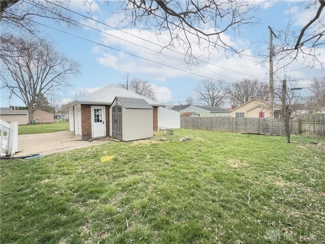 111 W Pinehurst St, Sidney, OH 45365 - view of yard featuring a patio, a storage unit, fence, and an outdoor structure