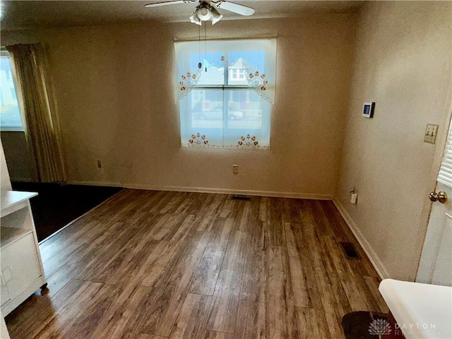 unfurnished dining area with ceiling fan and wood-type flooring