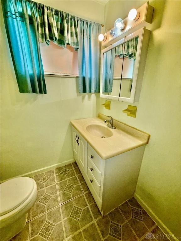 bathroom with vanity, tile patterned floors, and toilet