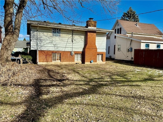 back of house featuring a lawn