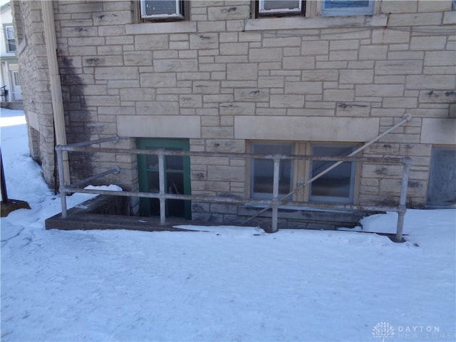 view of snow covered rear of property