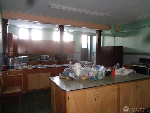 kitchen with black range with gas stovetop and a kitchen island