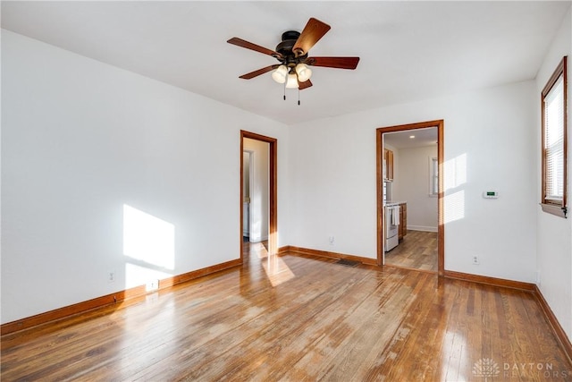 unfurnished room with ceiling fan and light wood-type flooring