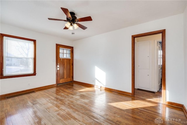 foyer with ceiling fan and light wood-type flooring