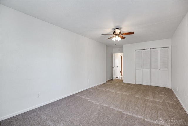 unfurnished bedroom with ceiling fan, carpet flooring, and a closet