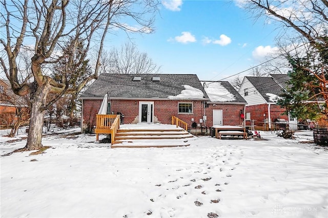 snow covered property featuring a deck