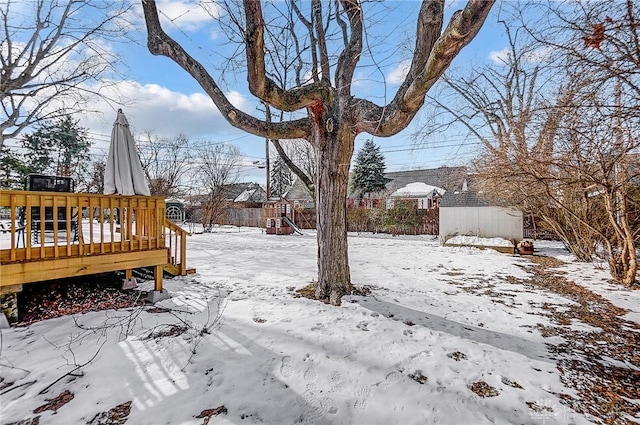 yard covered in snow featuring a wooden deck