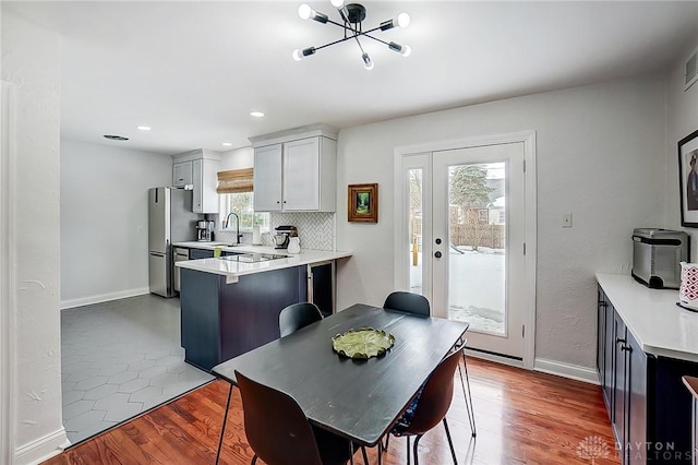 dining space featuring hardwood / wood-style floors and sink