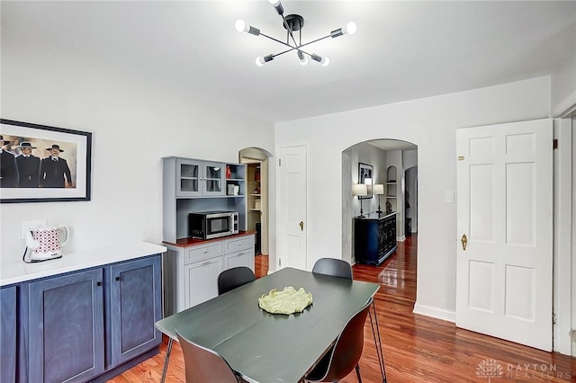 dining space featuring dark wood-type flooring