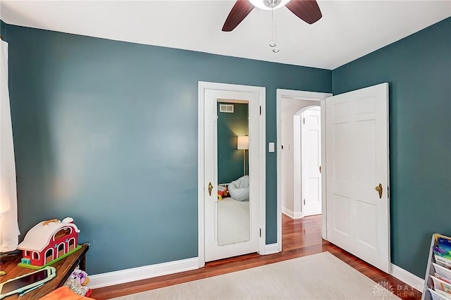 playroom with hardwood / wood-style flooring and ceiling fan