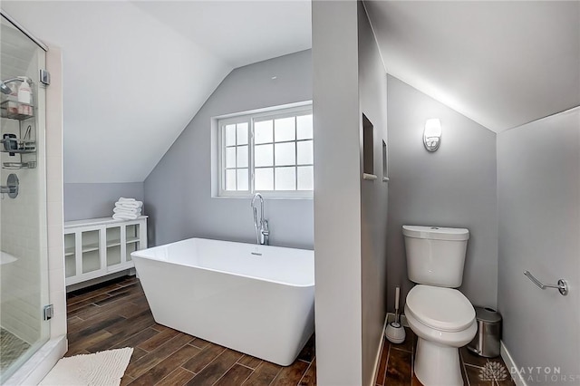 bathroom featuring lofted ceiling, separate shower and tub, and toilet