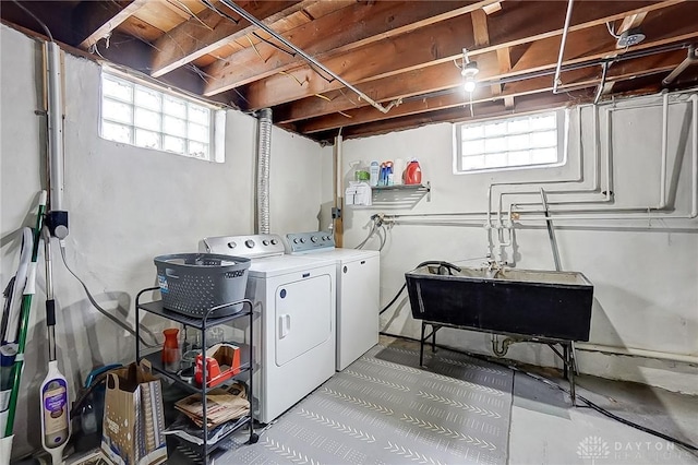 laundry area featuring washing machine and clothes dryer and sink