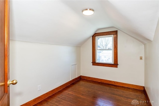 additional living space with lofted ceiling and dark wood-type flooring