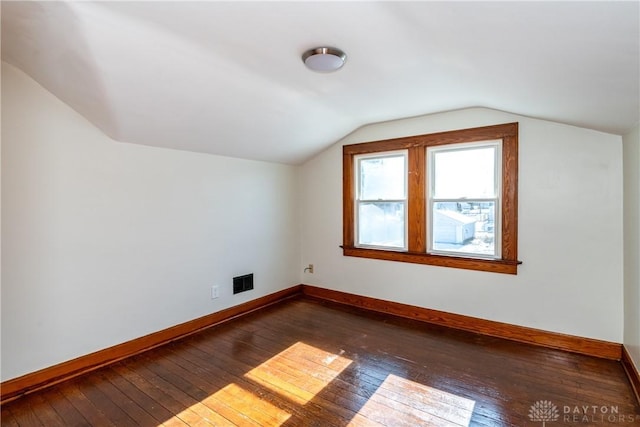 bonus room featuring dark hardwood / wood-style flooring and vaulted ceiling