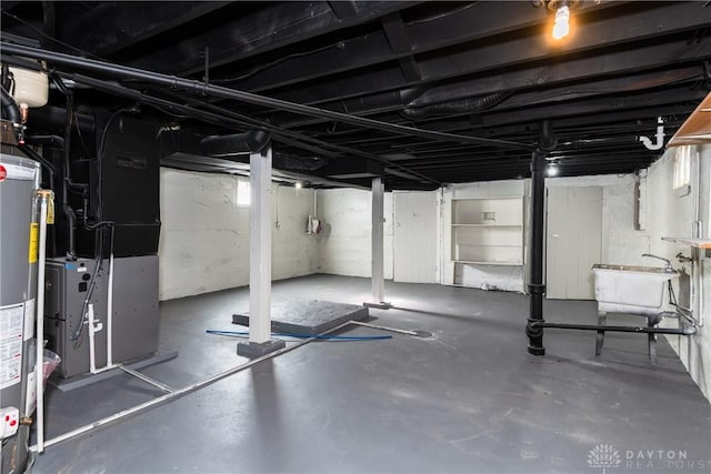 basement with sink, heating unit, and gas water heater