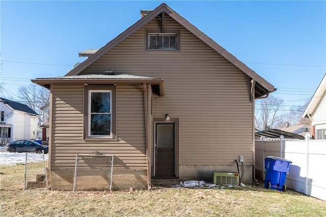 back of house with central AC