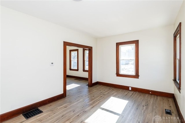 spare room featuring light hardwood / wood-style flooring