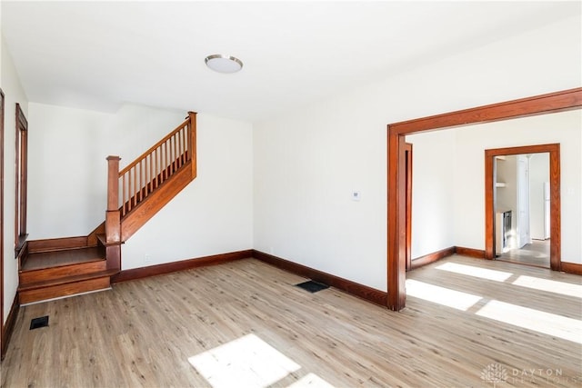 empty room with light hardwood / wood-style floors