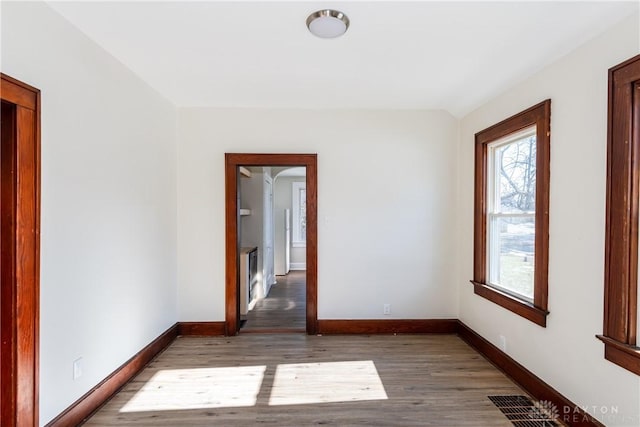 unfurnished room with dark hardwood / wood-style floors