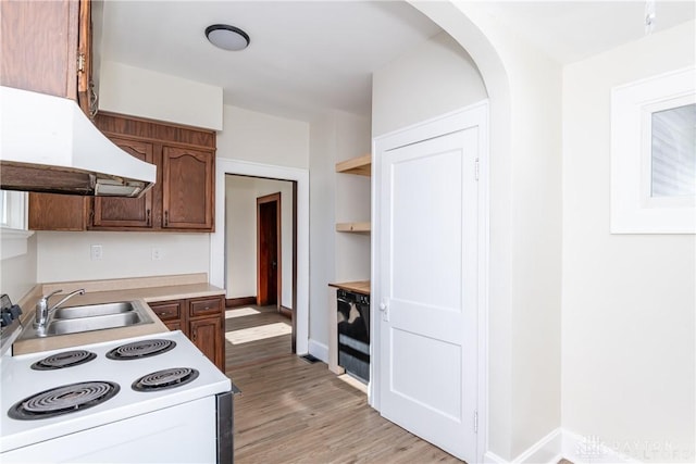 kitchen featuring sink, electric range, and light hardwood / wood-style floors