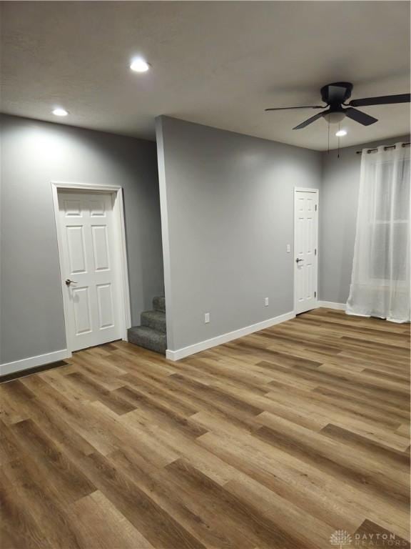 unfurnished room with hardwood / wood-style floors and ceiling fan