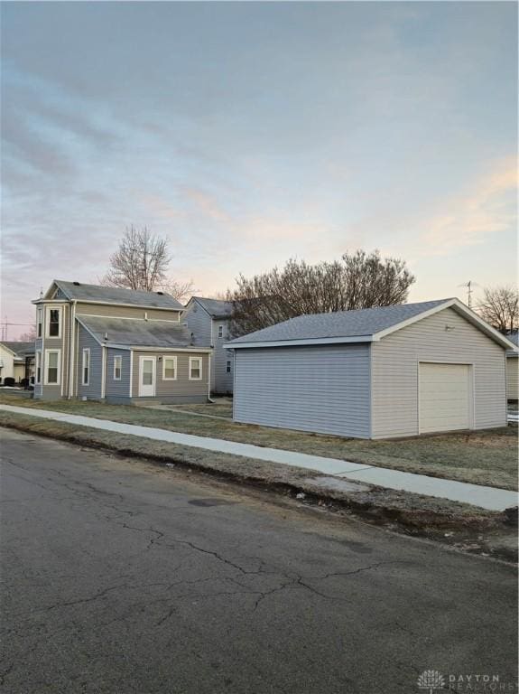 view of front facade featuring an outbuilding and a garage