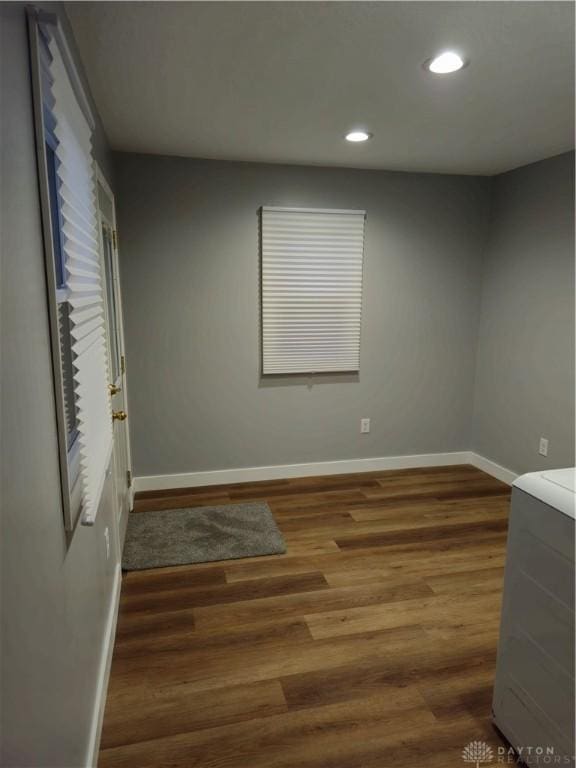 unfurnished room featuring dark hardwood / wood-style flooring and washer / clothes dryer