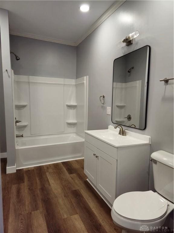 full bathroom featuring hardwood / wood-style floors, bathtub / shower combination, ornamental molding, vanity, and toilet