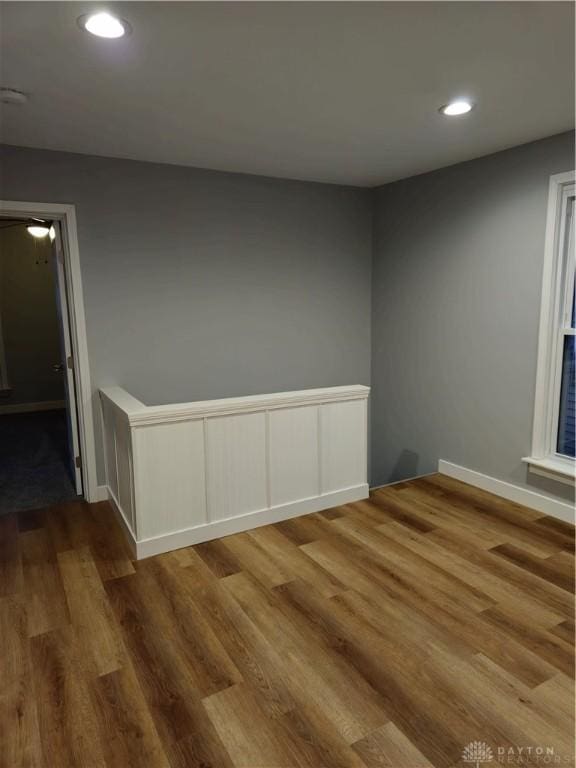 spare room featuring wood-type flooring