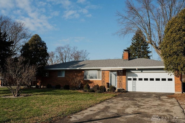 ranch-style home with a garage and a front lawn