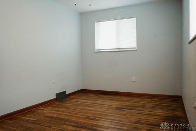 spare room with dark wood-type flooring