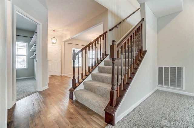 stairs featuring hardwood / wood-style floors