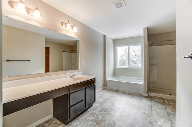 bathroom featuring vanity and separate shower and tub