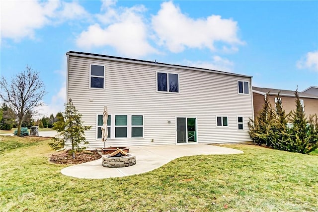 back of property featuring a yard, a patio, and an outdoor fire pit