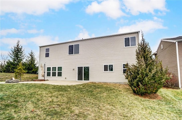 rear view of property with a yard and a patio