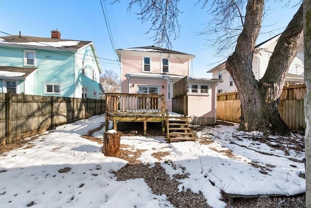 snow covered property featuring a deck