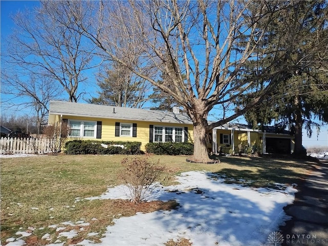 view of front of property with a lawn and a carport