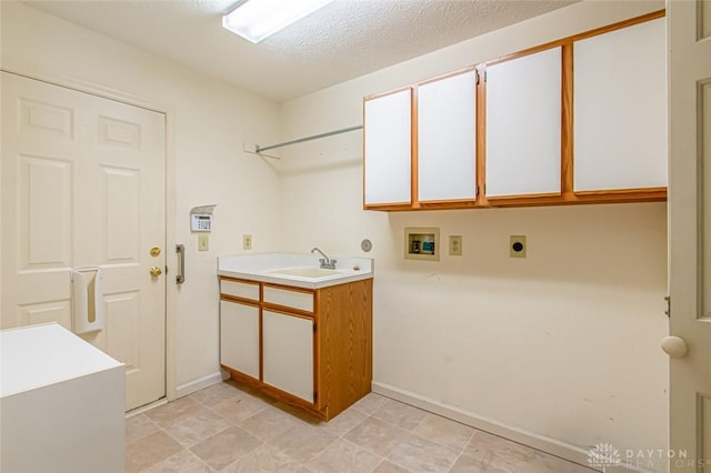 clothes washing area with sink, cabinets, washer hookup, electric dryer hookup, and a textured ceiling