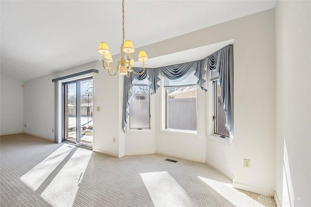 unfurnished dining area with light carpet and a notable chandelier