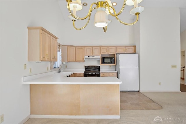 kitchen featuring a high ceiling, pendant lighting, kitchen peninsula, and black appliances