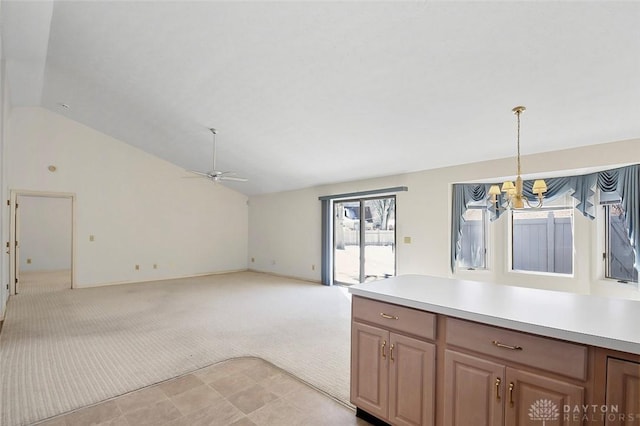 kitchen featuring light carpet, hanging light fixtures, vaulted ceiling, and ceiling fan