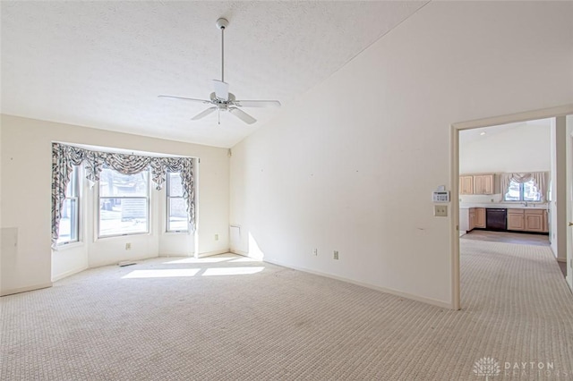 unfurnished room featuring ceiling fan, high vaulted ceiling, light carpet, and a textured ceiling