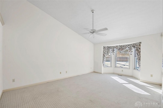 carpeted empty room featuring vaulted ceiling and ceiling fan