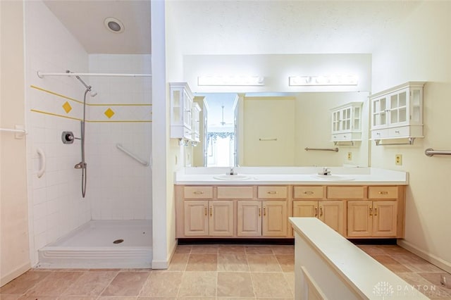 bathroom featuring vanity and a tile shower