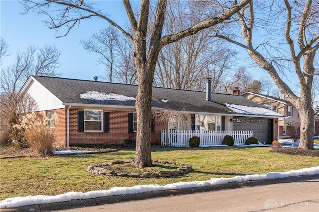 ranch-style house featuring a garage and a front lawn