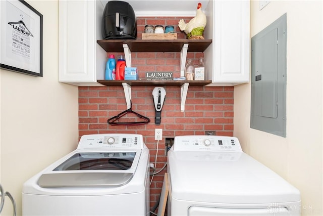 clothes washing area with cabinets, electric panel, and independent washer and dryer