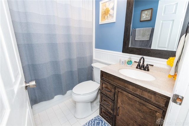 bathroom featuring tile patterned flooring, vanity, walk in shower, and toilet